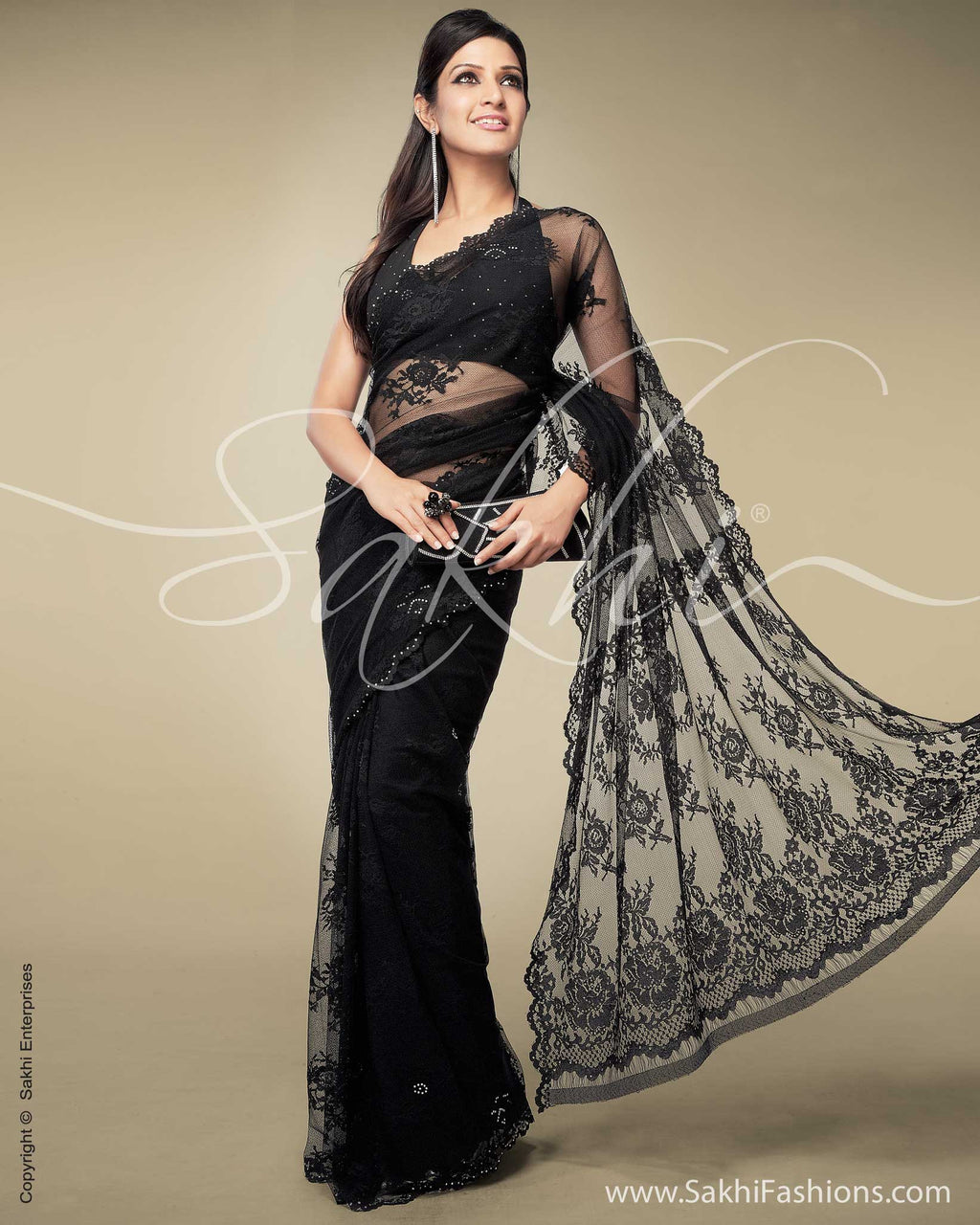 Asim Jofa - A black Chantilly Lace saree with heavy embellished embroidered  borders with Sequin spray sprinkled all over the saree with small bootis.  It comes with black skirt and black silk